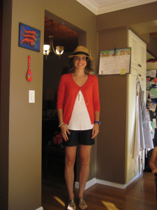 Red cardigan, with blue watch and pink nails